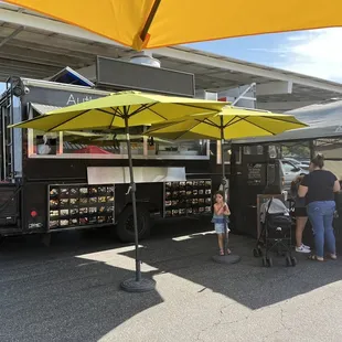 Food truck with umbrellas at the farmers market.