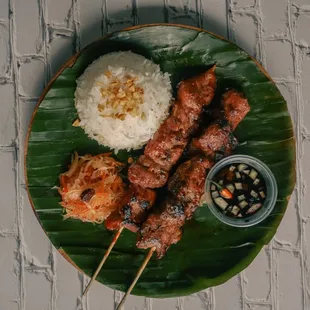 Pork BBQ served with rice, signature sauce and Atchara(pickled papaya).