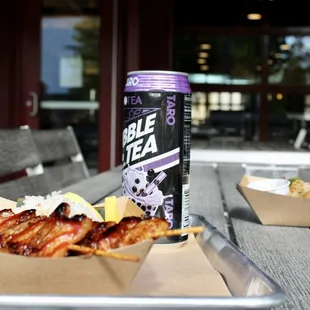 a tray of food and a can of beer