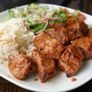 a plate of meat and rice