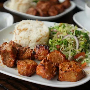 a plate of meat and rice