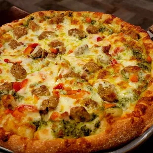 Pesto, sausage, pepper pizza