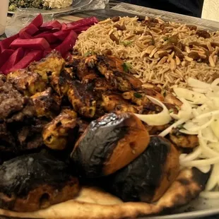 Custom family platter of various meats and rice.