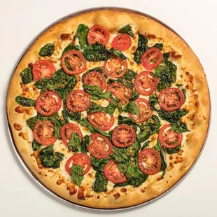 a pizza with tomatoes and spinach