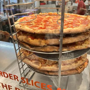 three pizzas on a rack