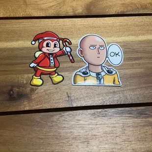 Santa Jollibee sticker and One Punch Man sticker found at the checkout counter.