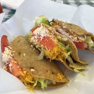 a taco with cheese and lettuce