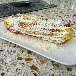 Crazy corn. Drizzled with ketchup, mustard, and cotija cheese. A bit odd, and pricey at $5. Good, but would skip next time.