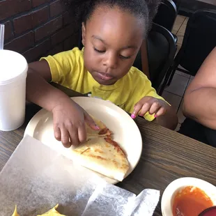 Jade enjoying a cheese quesadilla
