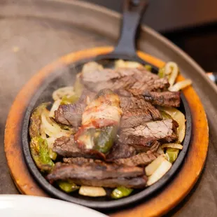 steak being cooked on a grill