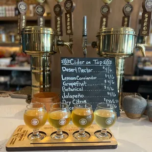 four glasses of cid on a serving tray