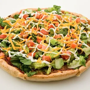 a pizza topped with lettuce, tomatoes, cheese, and cheese