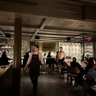 a waiter walking through a restaurant