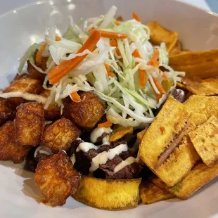 Fritanga bowl with mariquitas and repollo