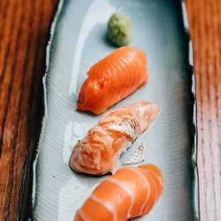 three pieces of salmon on a plate