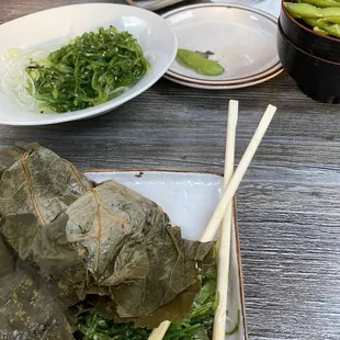 Seaweed salad, edamame and a sticky rice leaf wrap with mushrooms.