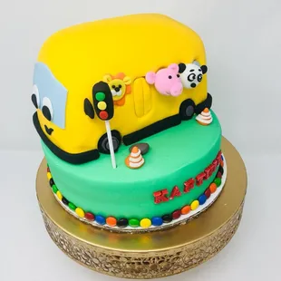 Wheels on the Bus Themed Cake - Mango Flavor White Chocolate Ganache, M&amp;Ms in the middle, they roll down when the cake is cut