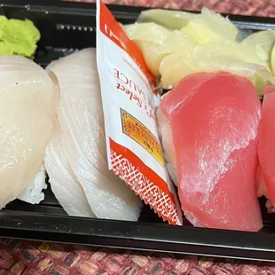 Variety of nigiri sushi and our rainbow roll cut in half.