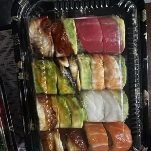 a variety of sashimis in a plastic container
