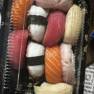 a plastic container filled with sushi