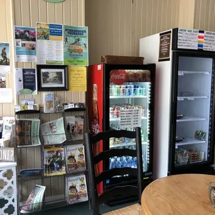 a table and chairs in front of a refrigerator