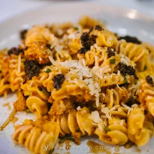 a plate of pasta with meat and cheese