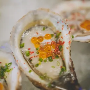 three oysters on a bed of ice