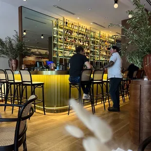 a bar with people sitting at it