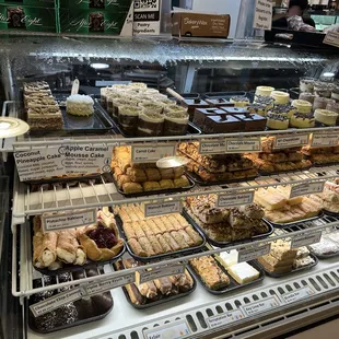 a variety of pastries in a display case