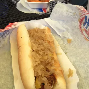 a hot dog with sauerkraut and onions