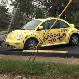 a yellow vw beetle parked on the side of the road