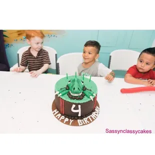 Our delicious and moist vanilla chocolate chip cake. A custom dinosaur themed cake filled with vanilla chocolate chip buttercream.