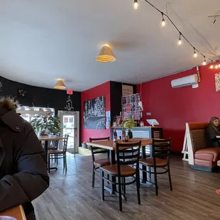 a woman sitting at a table in a coffee shop