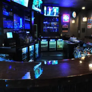 a bar with several televisions
