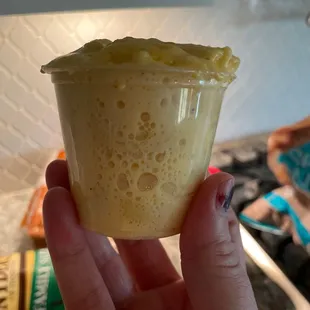 a person holding a cup of food