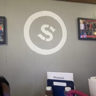 The logo on the wall