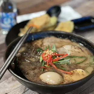 a bowl of ramen and chopsticks