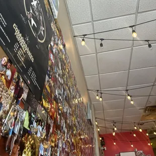 a wall full of pictures and lights