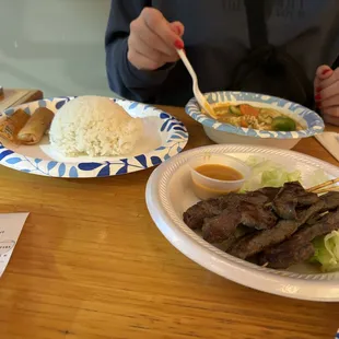 Beef Skewers (front), panang curry (back right), rice and 2 spring rolls (back left)