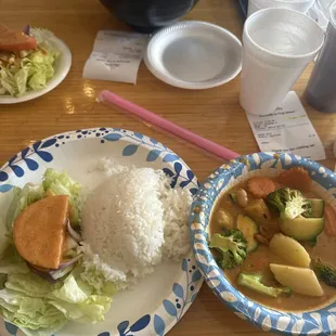 Massamam veggie curry and chicken soup with steamed rice and salad and spring roll.