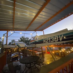 a restaurant with a boat in the background