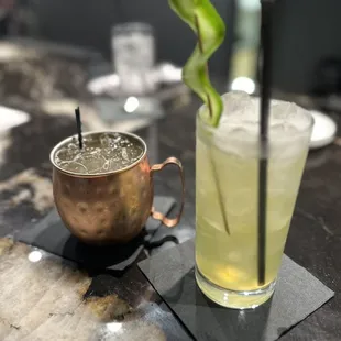 a cocktail and a copper mug