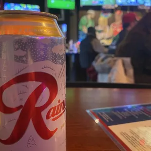 a can of beer sitting on a table