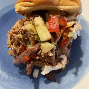a pulled pork sandwich on a blue plate