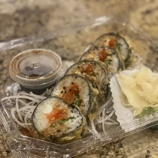 a sushi with a side of sauce
