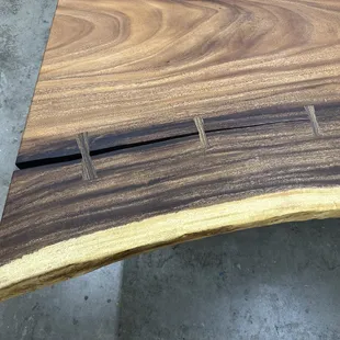 Live edge monkeypod dining table with bowties