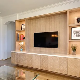 Custom media unit made of rift oak. Dimmable LED lights and stone countertop. Custom designed and built for a family home.