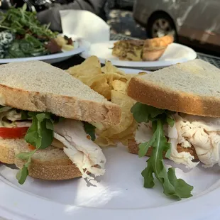 Turkey pesto on sourdough. Bacon, green onion, &amp; Swiss quiche in the back with the kale salad.