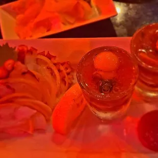 2 Quail Egg shooters Deluxe (octopus and salmon) and Tako sashimi w/ thin lemon slices