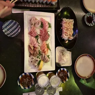 Deluxe sashimi plate with philly roll and California rolls for the kiddos.
